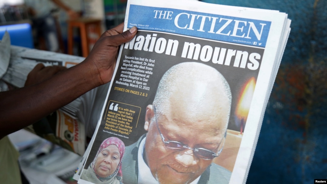 A man holds a newspapers following the death of Tanzania's President John Magufuli in Dar es Salaam, Tanzania, March 18, 2021.