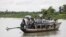 FILE - Rohingya Muslims travel on a boat along a river in Buthidaung township, Myanmar, June 7, 2015. A boat carrying more than 60 people capsized in rough waters off of Sittwe in Myanmar's Rakhine state Tuesday.