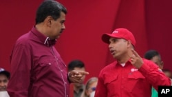 FILE - Venezuelan President Nicolas Maduro, left, speaks with Pedro Tellechea, then the oil minister and president of the Venezuelan state oil company PDVSA, in Caracas, Venezuela, May 1, 2023.