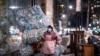 Une femme portant un masque facial et un sac en plastique tire un chariot chargé de sacs de matières recyclables dans les rues de Lower Manhattan lors de l'épidémie du nouveau COVID-19 le 16 avril 2020 à New York. (Photo de Johannes EISELE / AFP)