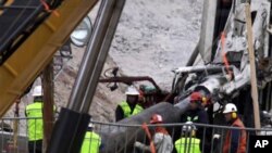 Rescue workers insert steel pipes to encase the escape tunnel that will be used to free trapped miners at the San Jose mine near Copiapo, Chile. 10 Oct 2010.