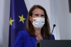 Belgian Prime Minister Sophie Wilmes, wearing a protective mask, prepares to address a press conference, in Brussels, Sept. 23, 2020.