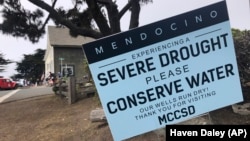 Signs alert visitors to the severe drought in Mendocino, Calif., on Wednesday, Aug. 4, 2021. (AP Photo/Haven Daley)