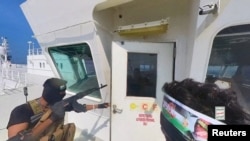 FILE - Houthi fighters open the door of the bridge on a ship's deck in the Red Sea in this photo released Nov. 20, 2023, by Houthi Military Media.