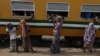 Passengers aboard an Ooni of Ife train to Kano, buy drinks and water at a train terminal in Mnna, Nigeria.