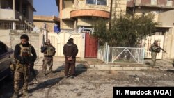 Iraqi forces guard suspected militants near the frontlines in Mosul, Jan. 13, 2017.