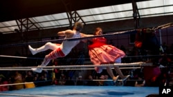 Veteran cholita wrestler Jennifer Dos Caras, 45, competes in the ring with Randy Four in El Alto, Bolivia, Jan. 21, 2019.