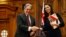 New Zealand First leader Winston Peters, left, and Prime Minister-designate Jacinda Ardern shake hands after signing a coalition agreement in Wellington, Oct. 24, 2017.