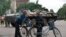 Local residents talk in front of an Ukrainian armored personnel carrier (APC) in the eastern Ukrainian city of Slavyansk.