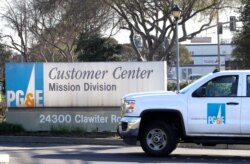 FILE - A Pacific Gas &amp; Electric truck enters their customer center in Hayward, Calif., Jan. 23, 2019.