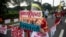 A protestor, maintaining social distancing from others to prevent the spread of coronavirus disease (COVID-19), holds a placard that reads "Human Rights Defenders are not terrorists" during a rally against the anti-terror bill in Manila.