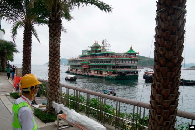 Hong Kong's iconic Jumbo Floating Restaurant is towed away in Hong Kong, Tuesday, June 14, 2022. (AP Photo/Kin Cheung)