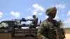 FILE - Soldiers from the Rwandan security forces are seen near the Afungi natural gas site, Mozambique Sept. 22, 2021.