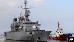 FILE - A tugboat escorts French Navy frigate Vendemiaire on arrival for a five-day goodwill visit at a port in Metro Manila, Philippines March 12, 2018. 