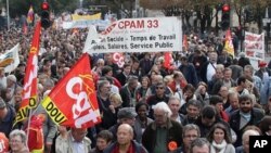 Demonstrators hold trade union flags during a demonstration in Bordeaux, southwestern France, 16 Oct 2010
