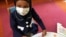 In this, May 2, 2017 photo, Amira Hassan plays in the waiting room at the specialty clinic at Children's Minnesota in Minneapolis. Hassan went to the hospital's clinic for a routine wellness check, but had to wear a mask to protect her from measles after an outbreak has sickened more than 30 children in Minnesota. 