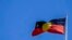 The Australian aboriginal flag flies on a building in Sydney, Australia, Oct. 7, 2021.