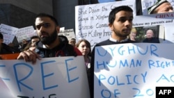 FILE - Uighur activists and their supporters rally in defense of Uighur rights in China, in front of the U.S. Mission to the United Nations, in New York City, on Feb. 5, 2019.