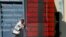 A woman walks past a currency exchange office in downtown Istanbul, Turkey, June 21, 2013. 