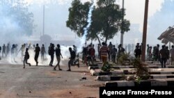 Sudanese protesters gather amid tear gas fired by security forces on al-Qasr street, during a demonstration against the Oct. 25 coup, in the capital Khartoum, Jan. 2, 2022. 