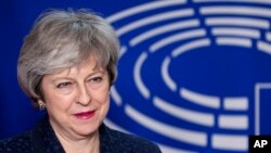 British Prime Minister Theresa May is welcomed by European Parliament President Antonio Tajani before their meeting at the European Parliament in Brussels, Feb. 7, 2019. 