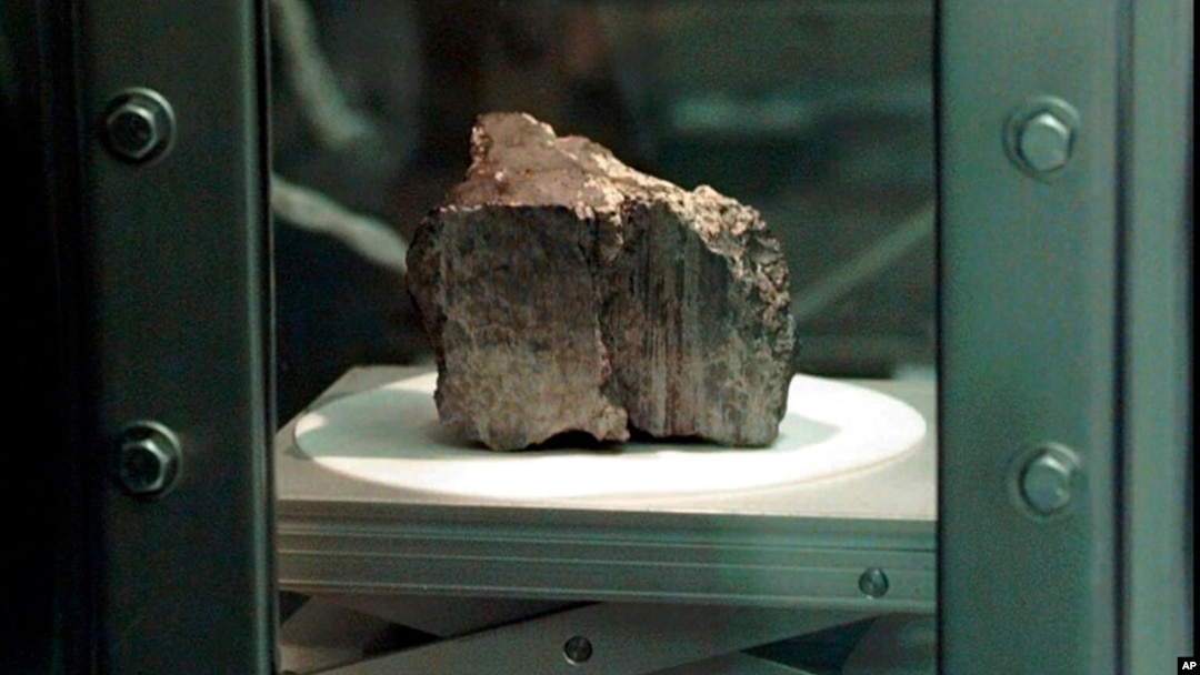 FILE - The meteorite labeled ALH84001 sits in a chamber at a Johnson Space Center lab in Houston, Aug. 7, 1996. Scientists say they've confirmed the meteorite from Mars contains no evidence of ancient Martian life. 