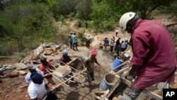 FILE—Members of Kyemoo Power, a self-help group, construct a sand dam in Makueni County, Kenya on February 29, 2024