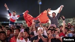 Migrant workers watch Qatar v Ecuador match in Doha, Qatar on November 20, 2022. (REUTERS/Marko Djurica)