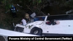 Rescuers work to free victims from inside the overturned bus in Anton, Cocle, Panama.