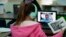 Students at Driggers Elementary School attend a class in-person as they interact with classmates virtually, Monday, Feb. 8, 2021, in San Antonio. (AP Photo/Eric Gay)