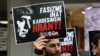 FILE - People hold placards with photographs of Turkish-Armenian journalist Hrant Dink during a gathering to commemorate the 13th anniversary of his death, in Ankara, Jan. 19, 2020.