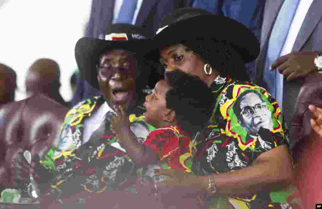 Le président zimbabwéen Robert Mugabe et sa femme Grace, à droite, ontemplent leur petit-fils lors de la célébration de 93 ans d'anniversaire du chef d’Etat du Zimbabwe à Matopos, dans la banlieue de Bulawayo, 25 février 2017.