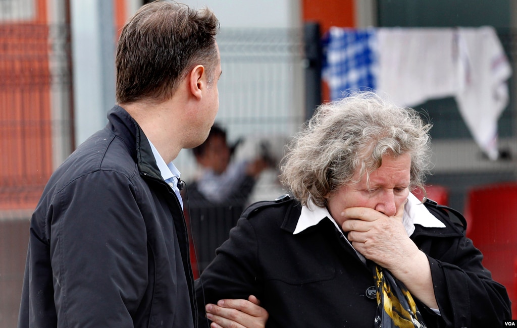 A woman and a man react right after an earthquake in Sant'Agostino, May 20. 2012. A magnitude-5.9 earthquake shook northern Italy toppling some buildings, emergency services and news reports said. (AP Photo/Luca Bruno)