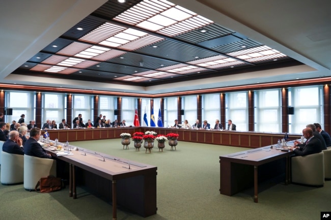 FILE - Delegations from Sweden, Turkey, Finland and NATO gather in Ankara, Turkey, on June 14, 2023. The NATO alliance was pressing Turkey to move ahead with the ratification of Sweden's application to join the military bloc. (Turkish Presidency via AP)