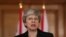 FILE - Britain's Prime Minister Theresa May makes a statement about Brexit in Downing Street in London, March 20, 2019.