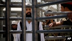 FILE - An Afghan prisoner waits in line for his release from Parwan Detention Facility after the U.S. military gave control of its last detention facility to Afghan authorities in Bagram, outside Kabul, Afghanistan, March 2013.