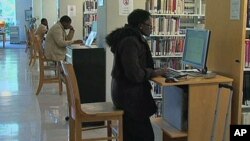 Administrators at Tidewater Community College in Virginia have launched a program to help prevent a tuition-loan crisis at their school, where students are shown working on computers in the college library, Norfolk, Virginia, November 2011.