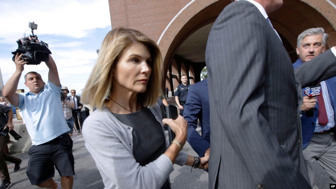 FILE - Actress Lori Loughlin departs federal court in Boston after a hearing in a nationwide college admissions bribery scandal, Aug. 27, 2019.