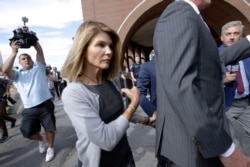 FILE - Actress Lori Loughlin departs federal court in Boston after a hearing in a nationwide college admissions bribery scandal, Aug. 27, 2019.