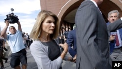 FILE - Actress Lori Loughlin departs federal court in Boston after a hearing in a nationwide college admissions bribery scandal, Aug. 27, 2019.