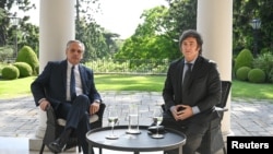 Argentina's current President Alberto Fernandez and President-elect Javier Milei meet at the Olivos Presidential Residence in Buenos Aires, on Nov. 21, 2023. (Argentine Presidency handout via Reuters)