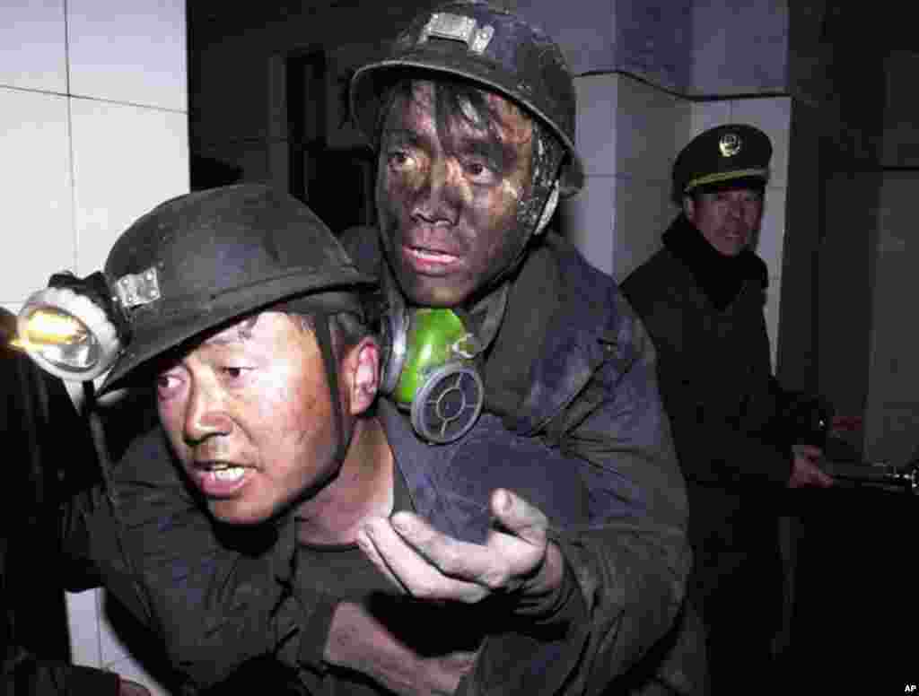 A rescued miner is carried above ground after a 2004 flooding accident at a coal mine in China's northwestern Xinjiang Uygur Autonomous Region. (AP Photo/Xinhua, Shen Qiao)