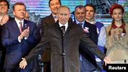 Russian President Vladimir Putin addresses the crowd during a concert marking the fifth anniversary of Russia's annexation of Crimea, in Simferopol, March 18, 2019.