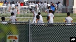 FILE - Immigrant children play outside a former Job Corps site that now houses them in Homestead, Florida, June 18, 2018. 