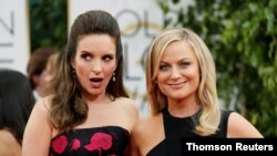 FILE - 2021 Golden Globes hosts Tina Fey and Amy Poehler pose at the 71st annual Golden Globe Awards in Beverly Hills, Calif., Jan. 12, 2014. 