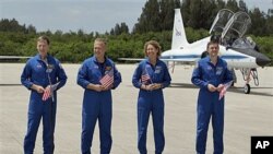 Atlantis [STS-135] crew members, from left, commander Chris Ferguson, pilot Doug Hurley, mission specialist Sandy Magnus and mission specialist Rex Walheim, speak to the media after arriving at the Kennedy Space Center in Cape Canaveral, Florida, July 4, 