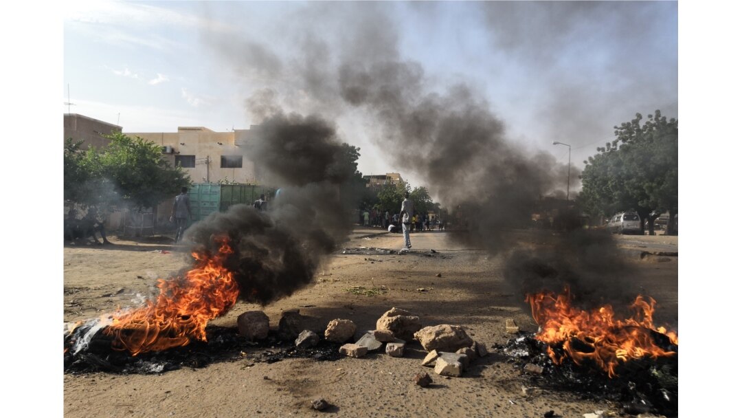 Tires are set ablaze by Sudanese protesters during a rally in the capital Khartoum, July 29, 2019. to condemn the "massacre" of five demonstrators including four high school students at a rally in Al-Obeida.