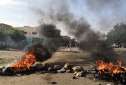 Tires are set ablaze by Sudanese protesters during a rally in the capital Khartoum, July 29, 2019. to condemn the "massacre" of five demonstrators including four high school students at a rally in Al-Obeida.