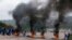 Supporters of former South African President Jacob Zuma block the freeway with burning tyres during a protest in Peacevale, South Africa, July 9, 2021.