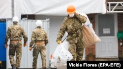 U.K. -- Army officers wearing combat uniform are seen carrying bags after removing what is believed to be part of the roof at the house of former Russian spy Sergei Skripal in Christie Miller Road in Salisbury, February 4, 2019